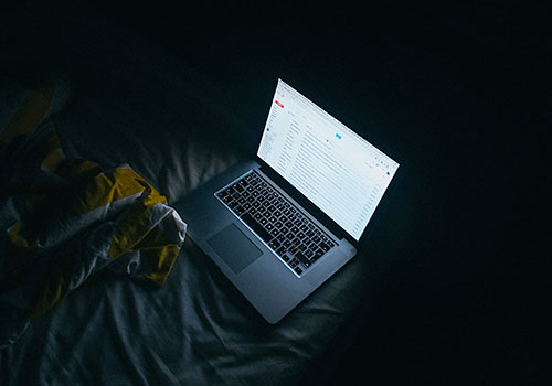 Laptop in the dark, cyberbulling research by University of Guelph professor Ryan Broll.