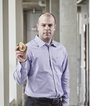 A photo of Prof. Paul Spagnuolo holding an avocado