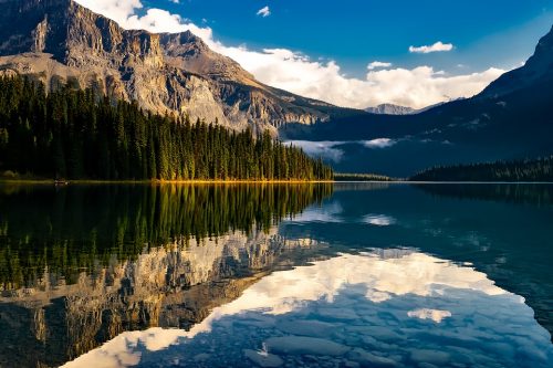 Mountains and sky reflected in glassy water