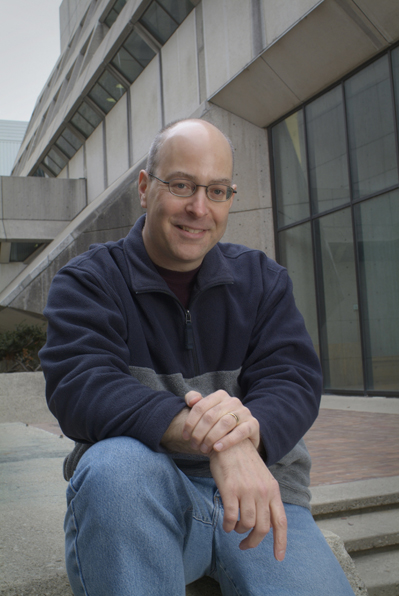 Prof. Eric Poisson sitting on steps outside a building