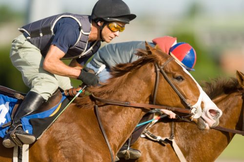 photo of jockey riding a racehorse