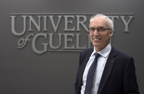 photo of U of G president Franco Vaccarino in front of a University of Guelph sign