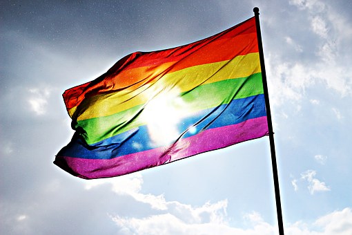 pride rainbow flag with sun shining through