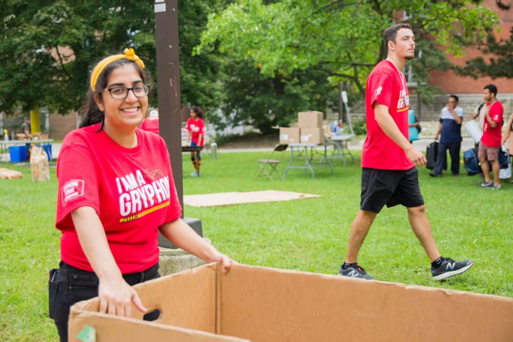 O-Week volunteer helping with moving boxes