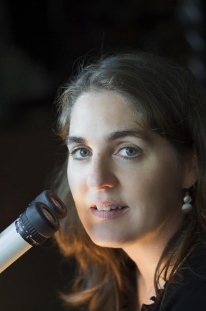 photo of Prof. Nina Jones next to a microscope