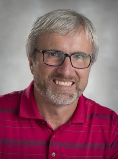 Art Hill in red shirt and glasses