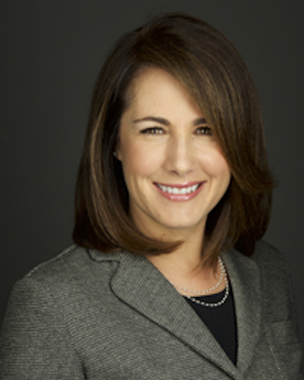 Tanay Mark smiling in gray jacket