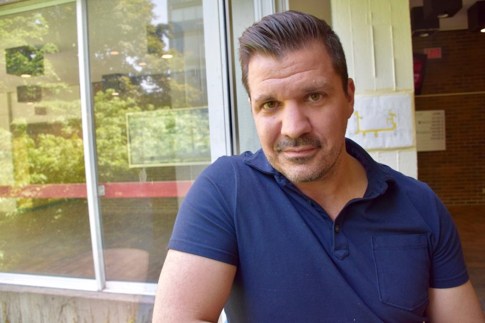 Man in outdoor campus scene