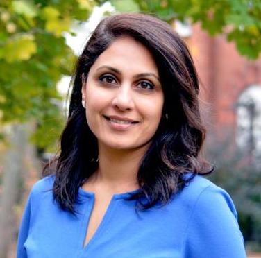 Dr. Nita Chhinzer smiles for a portrait in an outdoor setting.