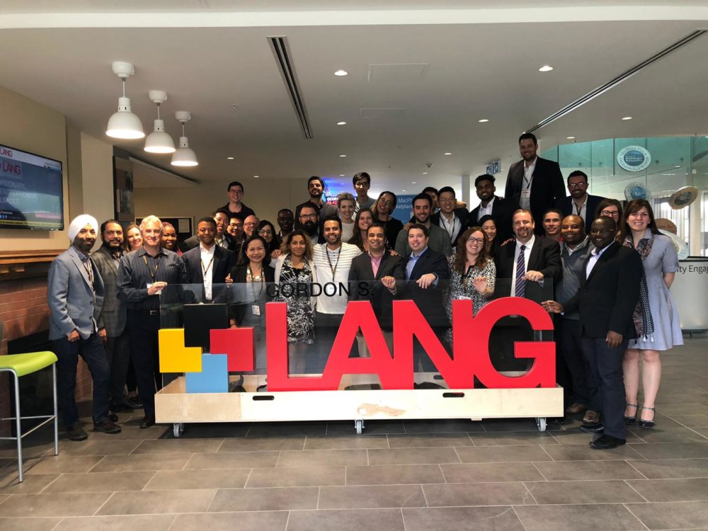 Students gather around the Lang sign