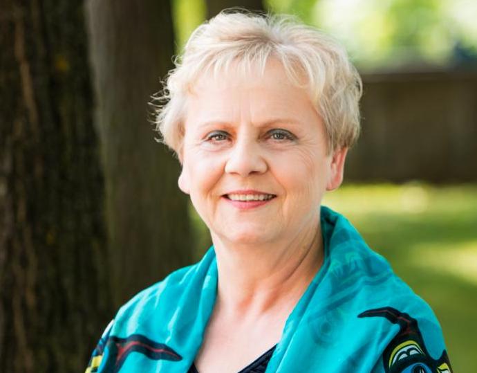 woman outdoors smiles at camera
