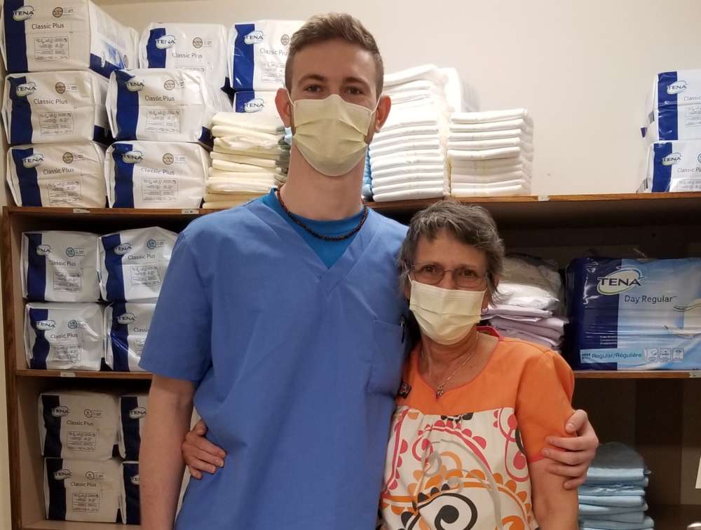 Tall man and woman wearing protective masks