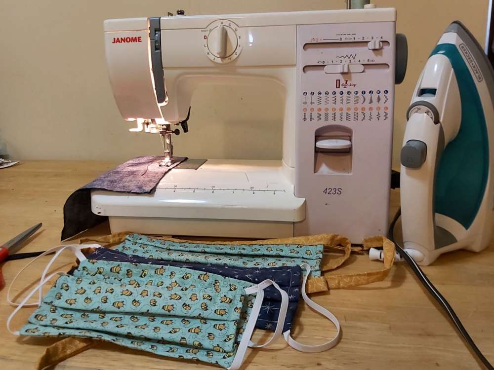 A sewing machine with several hand-sewn masks
