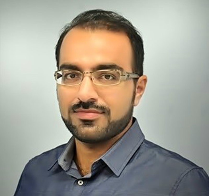 Dr. Ali Dehghantanha poses for a headshot against a light grey backdrop.