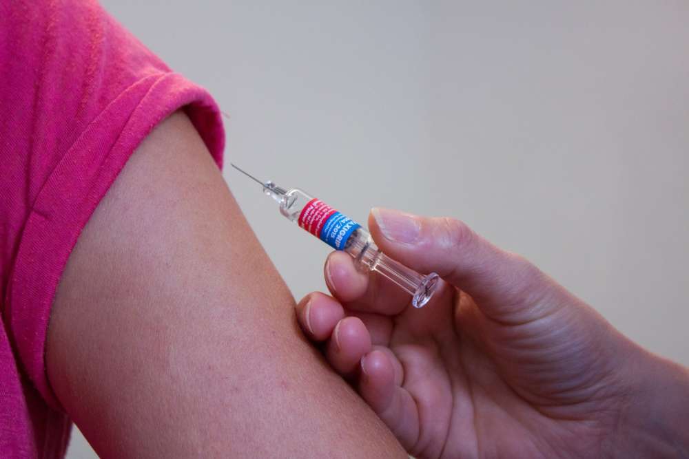 A needle is shown next to an arm