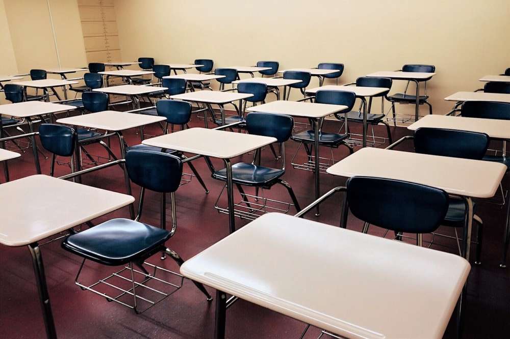 A classroom full of empty desks is shown.