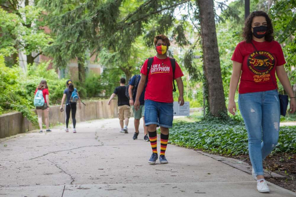 U of G students wearing masks walk along campus paths