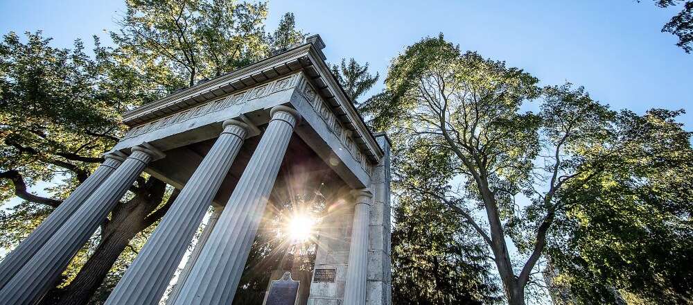 Portico on U of G Campus with sunbeams peeking through the columns