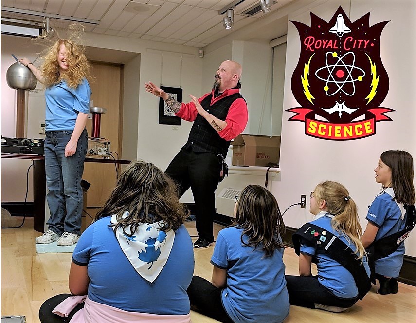 Girl Guides sit before Orbax as he demonstrated a plasma ball.