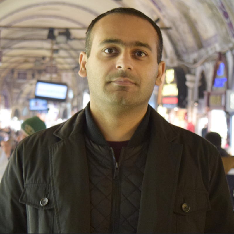 Dr. Hassan Khan poses for a photo at an event.