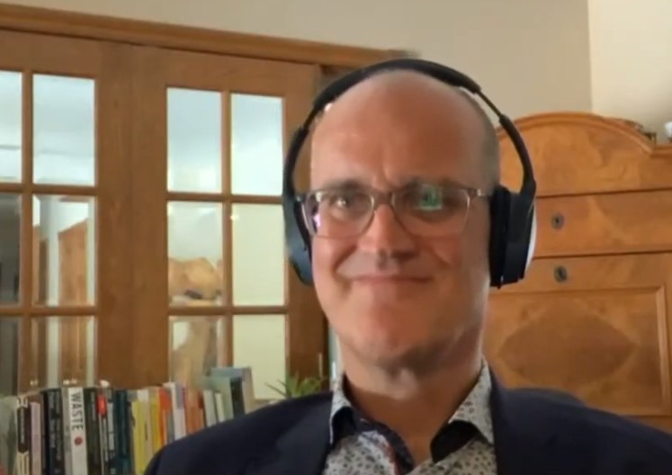 Dr. Mike Von Massow wears headphones while on a video call