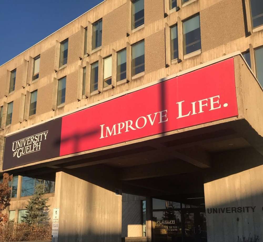 The University Centre on the U of G campus with a red sign that reads Improve Life