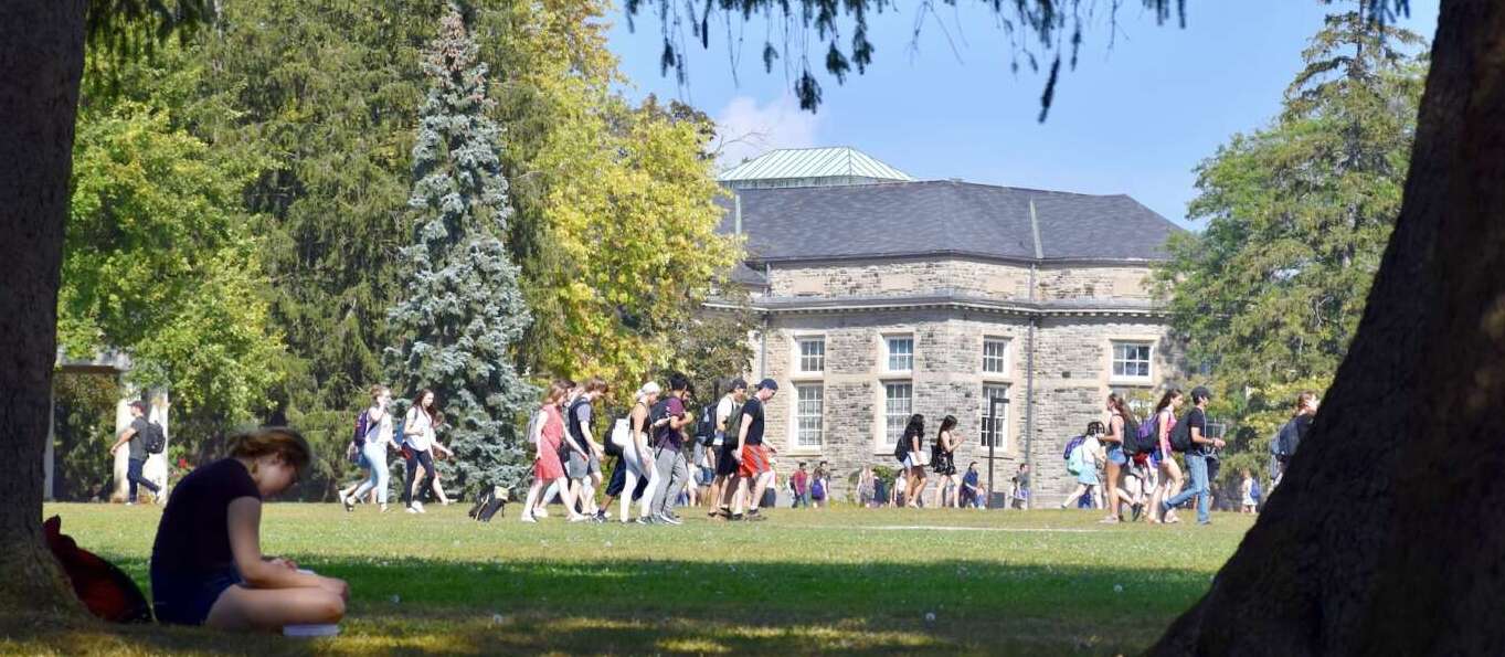 Students walk across Johnston Green on the U of G campus on a sunny day