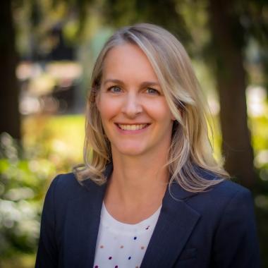 Dr. Carolyn Yule smiling in an outdoor setting
