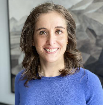 Dr. Maya Goldenberg in purple sweater facing camera