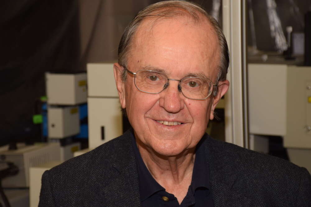 Male professor in laboratory setting.