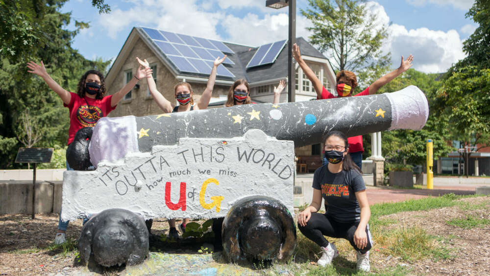 Five students wearing masks gather at the Cannon on the U of G campus