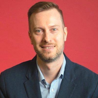 Dr. Simon Somogyi against a crimson background