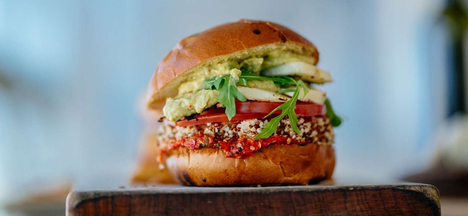 plant-based hamburger with sliced tomatoes and vegetables