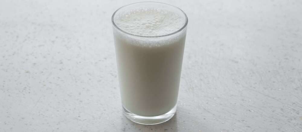 clear drinking glass with brown liquid