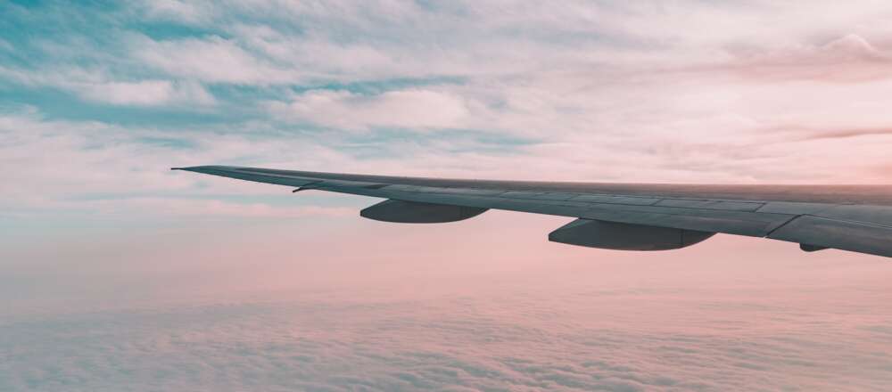 An airplane wing at sunset