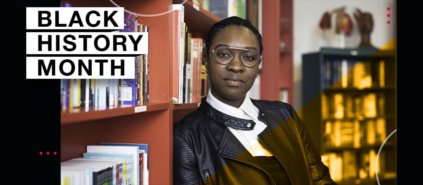 A person leans against a bookcase and smiles at the camera. Text reads Black History Month