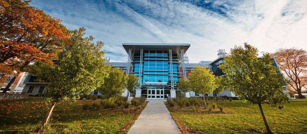 wide view of Alexander Hall and trees in early fall.