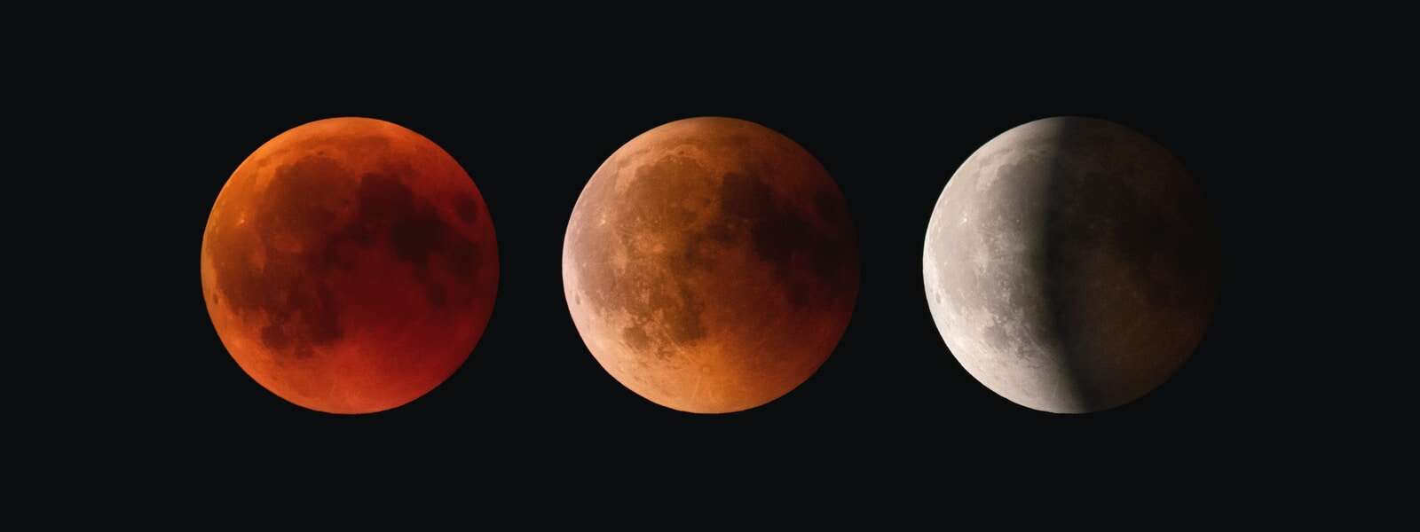 The moon during a different phases of a lunar eclipse. The first moon is full and red, the second (in the middle of the photo) is orange and partly in shadow, the last moon (to the right of the moon in the middle) is half in shadow and is white. All of the moons are set against a black background.