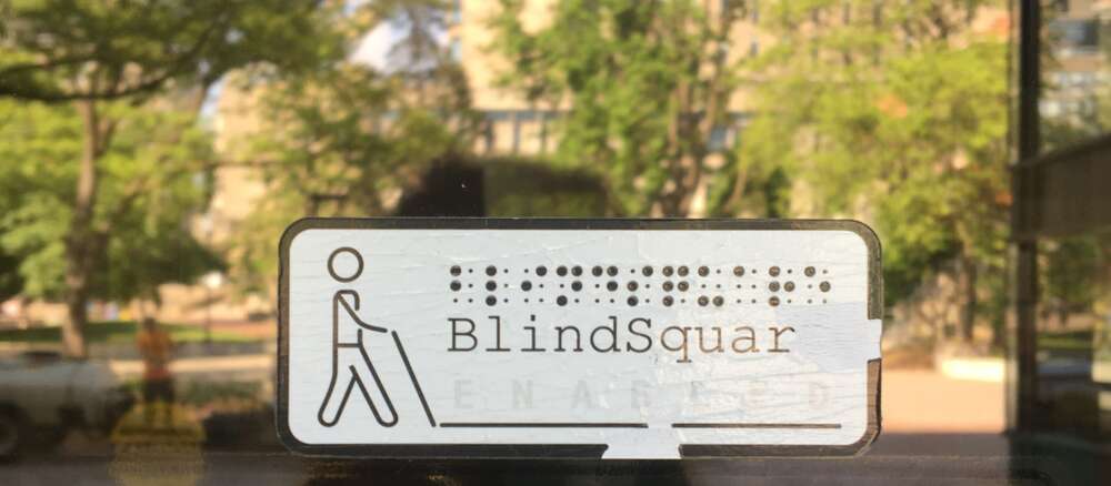A BlindSquare sign appears on a glass door of the University Centre