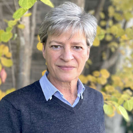 Dr. Dorothee Bienzle poses for a headshot in front of trees