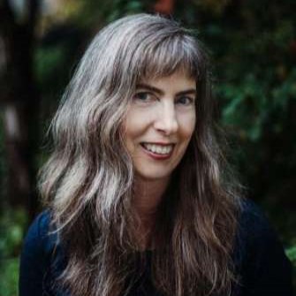 Dr. Catherine Bush poses for a photo in a garden
