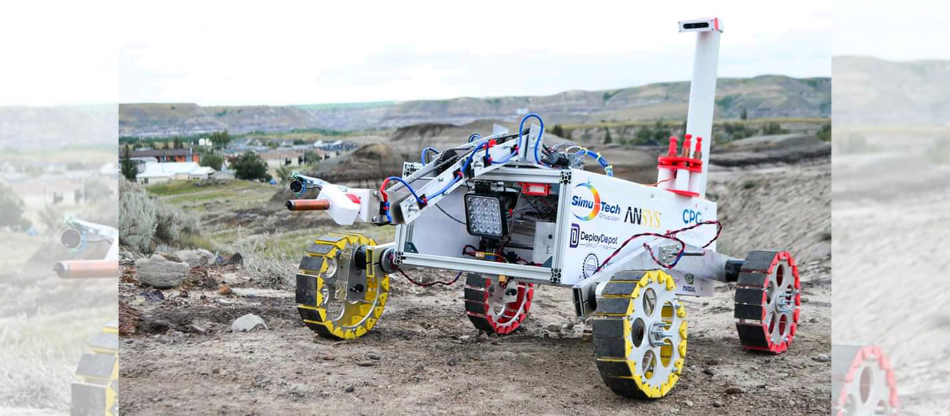 a rover wit hred and yellow wheels sits on the ground in the Alberta badlands