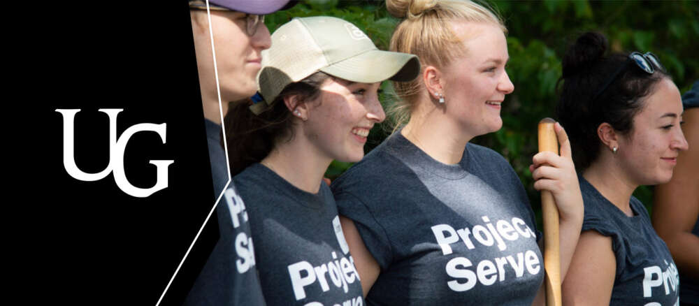 Students wearing Project Serve t-shirts stand holding shovels