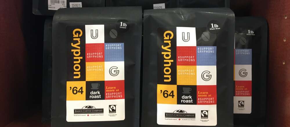 Black coffee packages with colourful designs arranged on a shelf