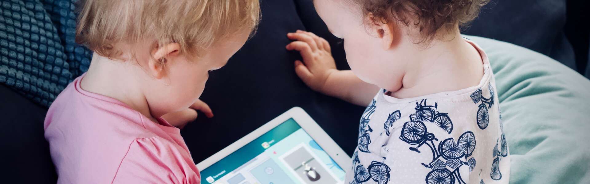 Toddlers use a tablet/