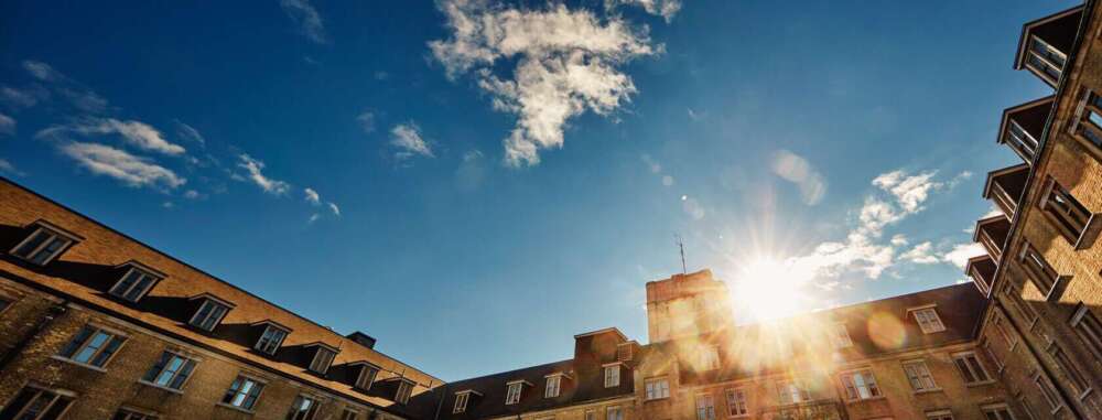 A setting sun over a building on the U of G campus
