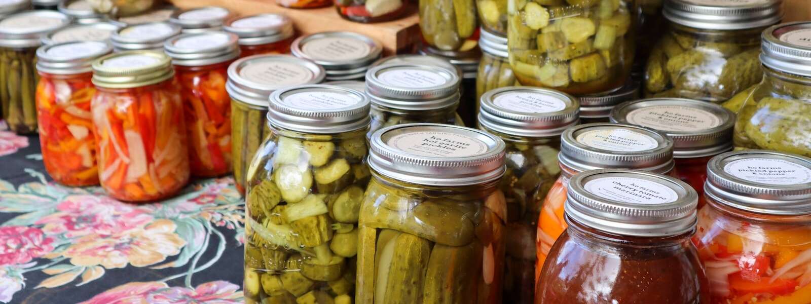 Clear glass jars with pickled goods inside