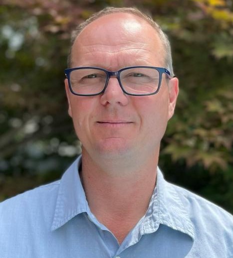 Dr. Andreas Heyland poses for a photo while standing outside