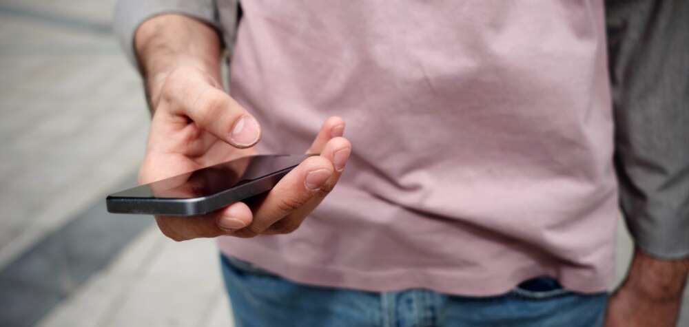 A closeup of a hand holding a cellphone