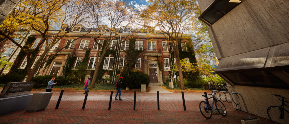 Students walk down the path in front of The H.L. Hutt Building.